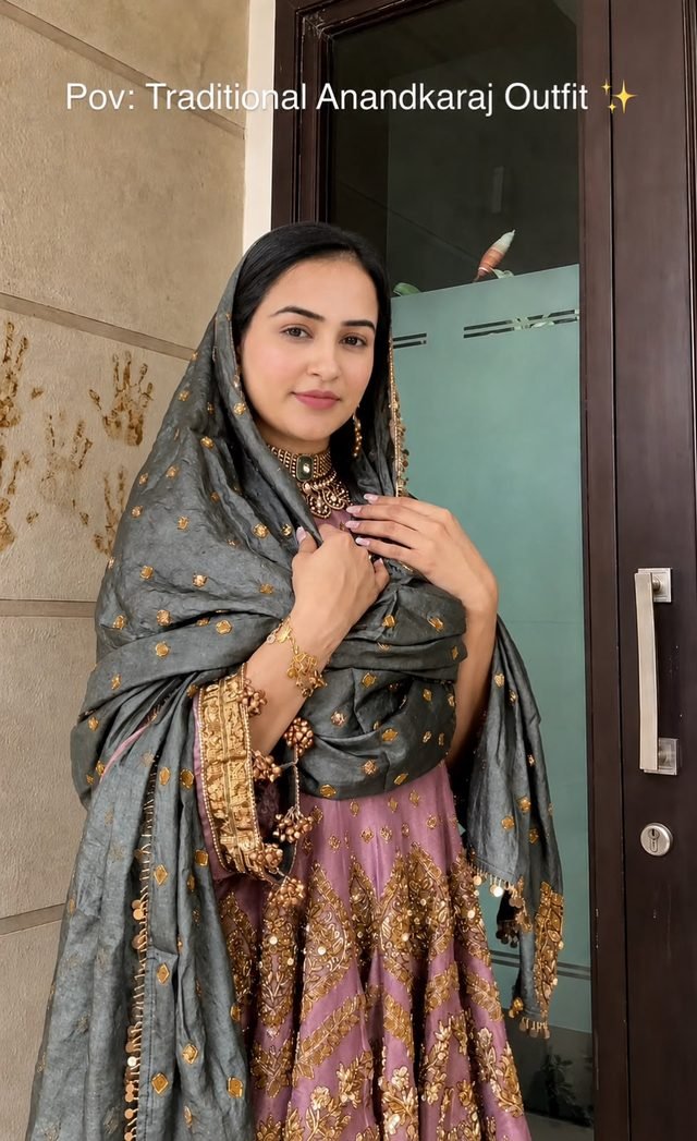 Woman in a mauve and gold embroidered outfit with a grey dupatta draped over her head, with the on-image text Pov: Traditional Anandkaraj Outfit